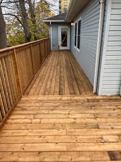Residential side yard with gravel pathway and wooden fence